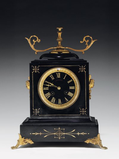 A mantle clock of black composition stone, with incised decoration, with legs, finials and fittings in gilt brass, by Jausions of Pau, France, c.1876-78dani af French School