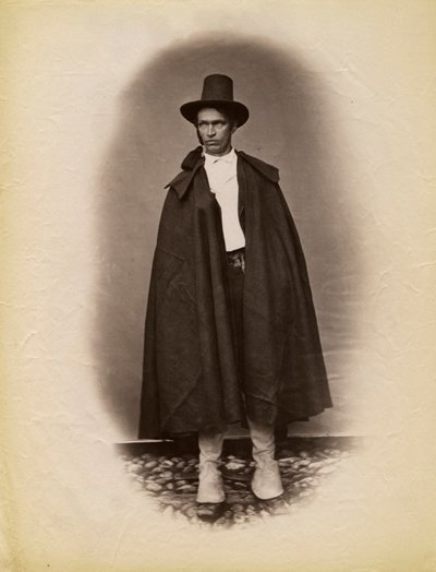 Ung mand iført kappe og hat, Parre, Lombardiet, Italien, fotografi af Premiata Fotografia Taramelli, Bergamo af Italian Photographer