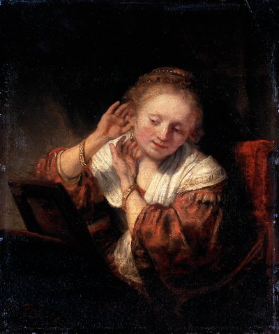 Ung kvinde prøver øreringe, 1657. af Rembrandt van Rijn