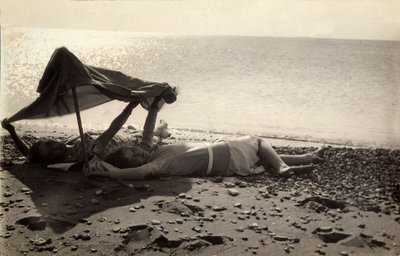 To kvinder ligger på stranden i skyggen af et håndklæde. Postkort sendt af fotografen til Vincenzo Balocchi af Vincenzo Balocchi