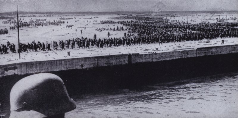Tysk soldat undersøger allierede fanger på stranden ved Dunkerque, Frankrig, Anden Verdenskrig, juni 1940 (s/h foto) af Photographer German