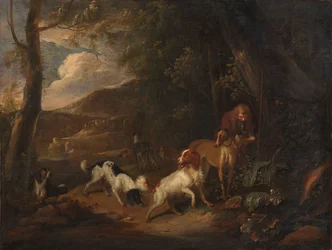 Jæger med hunde i udkanten af en skov