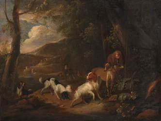 Jæger med hunde i udkanten af en skov