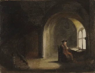 Mand siddende ved et vindue