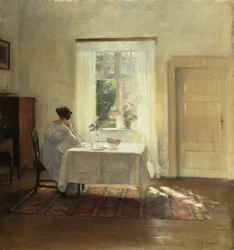 En kvinde siddende ved et bord ved et vindue, ca. 1900