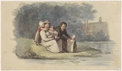 Familie sidder ved vandet