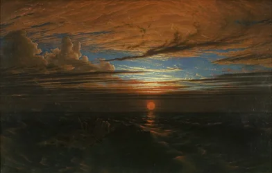 Solnedgang til søs efter en storm
