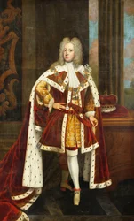 Portræt af kong George II, da prinsen af Wales, i fuld længde, iført statskåber og halsbåndet af strømpebåndsordenen, med sit sværd i venstre hånd og sin krone på et bord ved siden af ham, i et interiør,