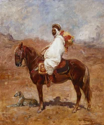 En araber på en hest i et ørkenlandskab