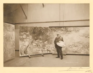 Claude Monet (1840-1926) foran sine malerier 