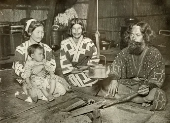 Ainu Man and Women at Home, 1910.