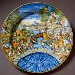 Episode fra forsvaret af Pons Sublicius ved den legendariske romerske helt Horatius Cocles under kampene mod etruskerne. Keramisk fad fremstillet i Urbino på Fontana-værkstedet, Italien. Omkring 1560. Firenze, Museo Nazionale del Bargello