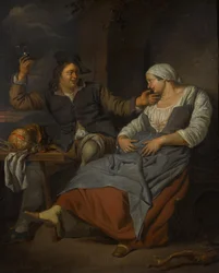 Et siddende par drikker vin