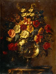 Blomster i en glasvase på en klippe,