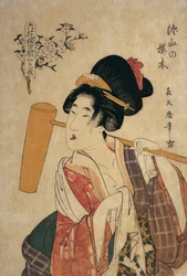 Nærbillede af en ung kvinde med en træstøder på skulderen