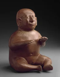 Siddende kvindelig billedfigur