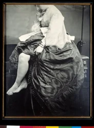 Grevinde Verasis de Castiglione, født Virginia Oldoini, siddende på et bord. Grevinden løfter sin kjole for at blotlægge ben og fødder. Sølvgelatinebromidprøve, 1863, Paris, Musée d