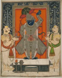 Præster, der tilbeder Krishna som Shrinathji til Mountain of Food -festivalen [Annakuta utsava]; helligdom hængende [pichhavai]