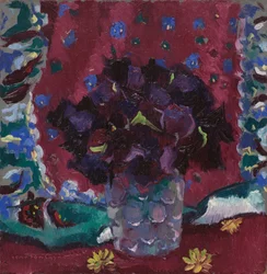 Blå stedmoderblomster i et glas