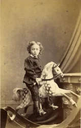 Ung dreng siddende på en gyngehest, 1860