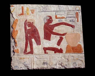 Oldegyptisk kunst: bagning af brød. En mand laver kagedej, en anden overvåger bagningen af brødforme. Kalksten (2500-2350 f.Kr.), 5. dynasti. Paris, Musée du Louvre
